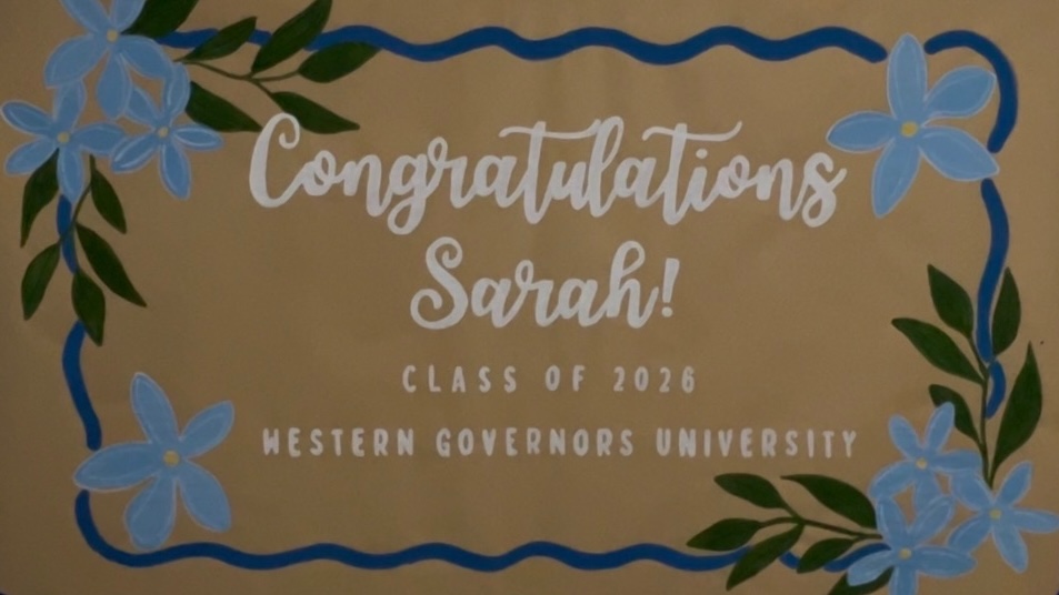 Hand-painted 'Congratulations Sarah' graduation banner with blue florals
